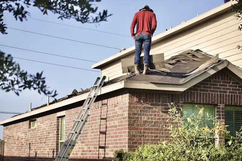 Professional roofer working on a residential roof in East Chastain Park